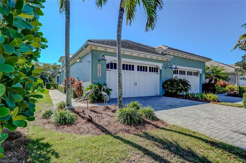 View of property exterior featuring stucco siding, a garage, and a lawn