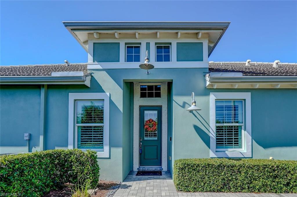 View of front facade with stucco siding, an attached garage, decorative driveway, and a tile roof