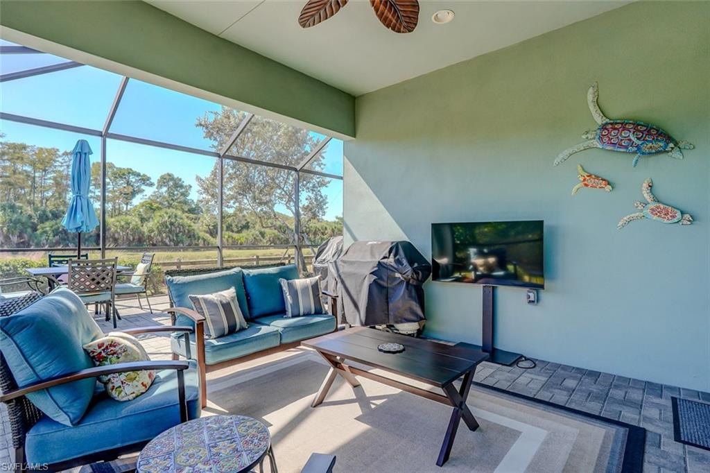 View of patio / terrace with a sunroom, area for grilling, a lanai, and outdoor dining space