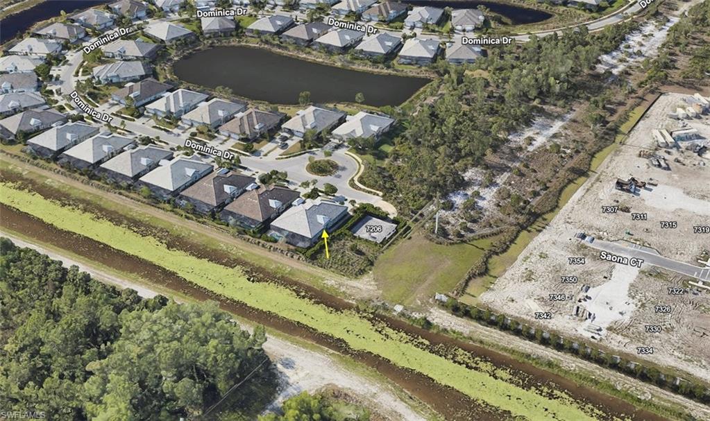 Aerial view of property and surrounding area with a large body of water and nearby suburban area