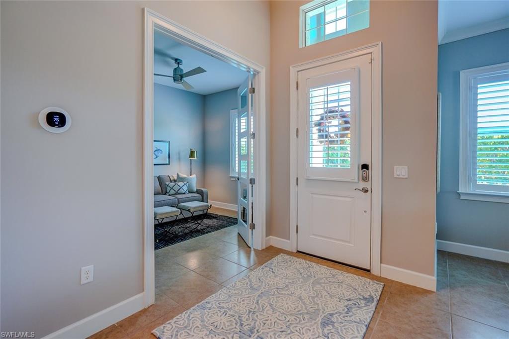 Entrance foyer featuring a ceiling fan and light tile patterned floors