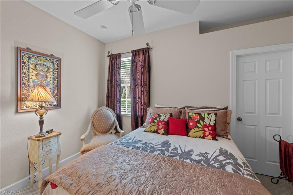 Carpeted bedroom with baseboards and ceiling fan