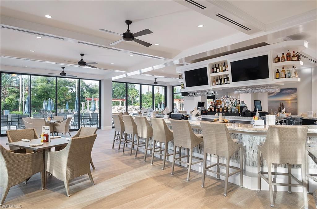 Bar area with beamed ceiling and light stone countertops
