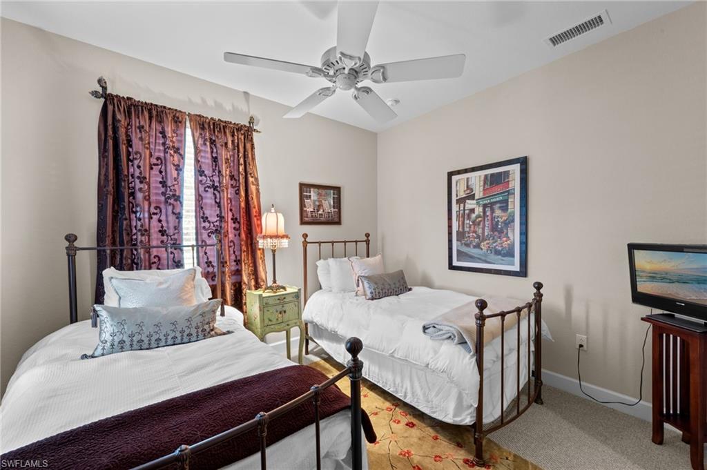 Carpeted bedroom with baseboards and a ceiling fan