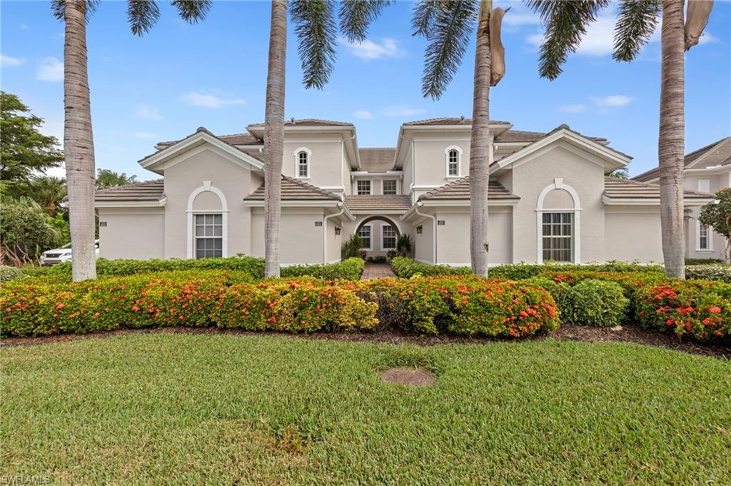Mediterranean / spanish-style home with stucco siding, a front lawn, and a tile roof
