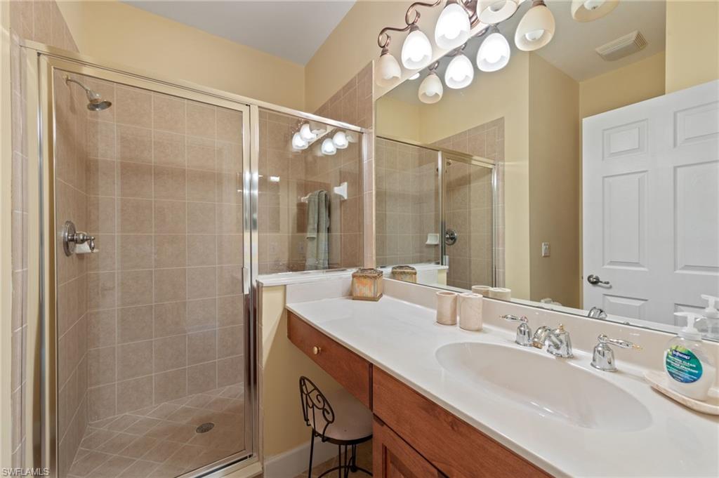 Bathroom featuring vanity and a stall shower