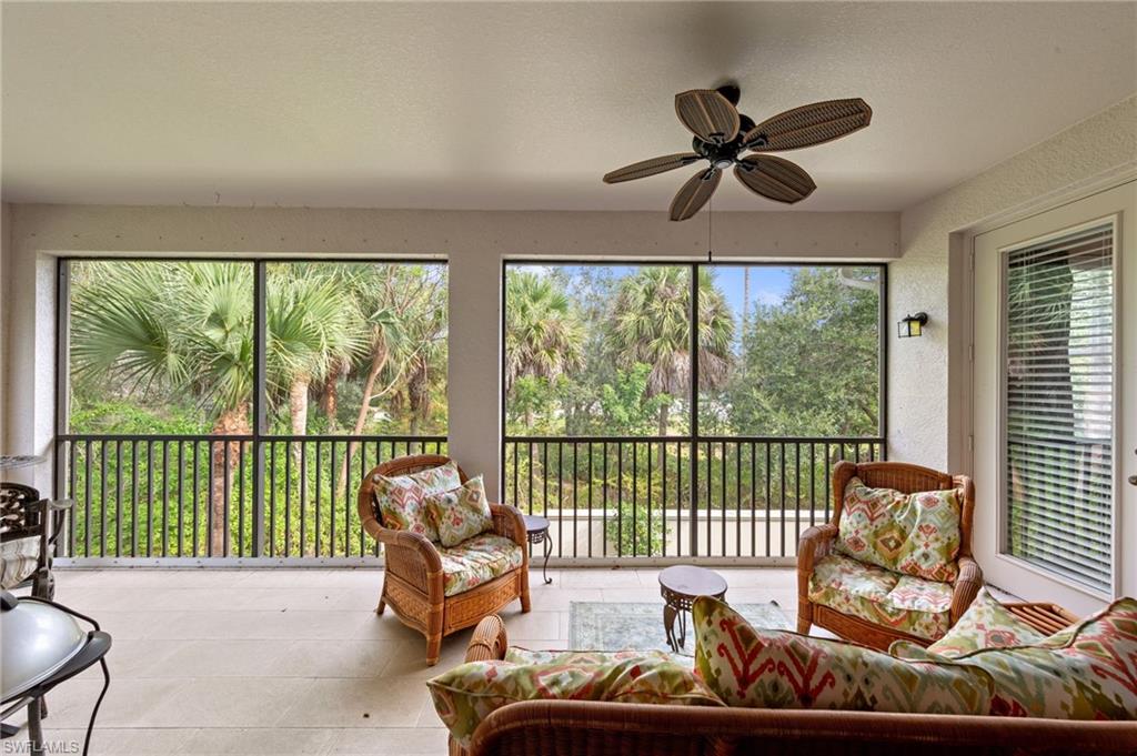 Sunroom / solarium with tile patterned flooring and a textured wall
