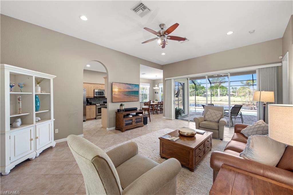 Living area with light tile patterned floors, a ceiling fan, recessed lighting, and a sunroom
