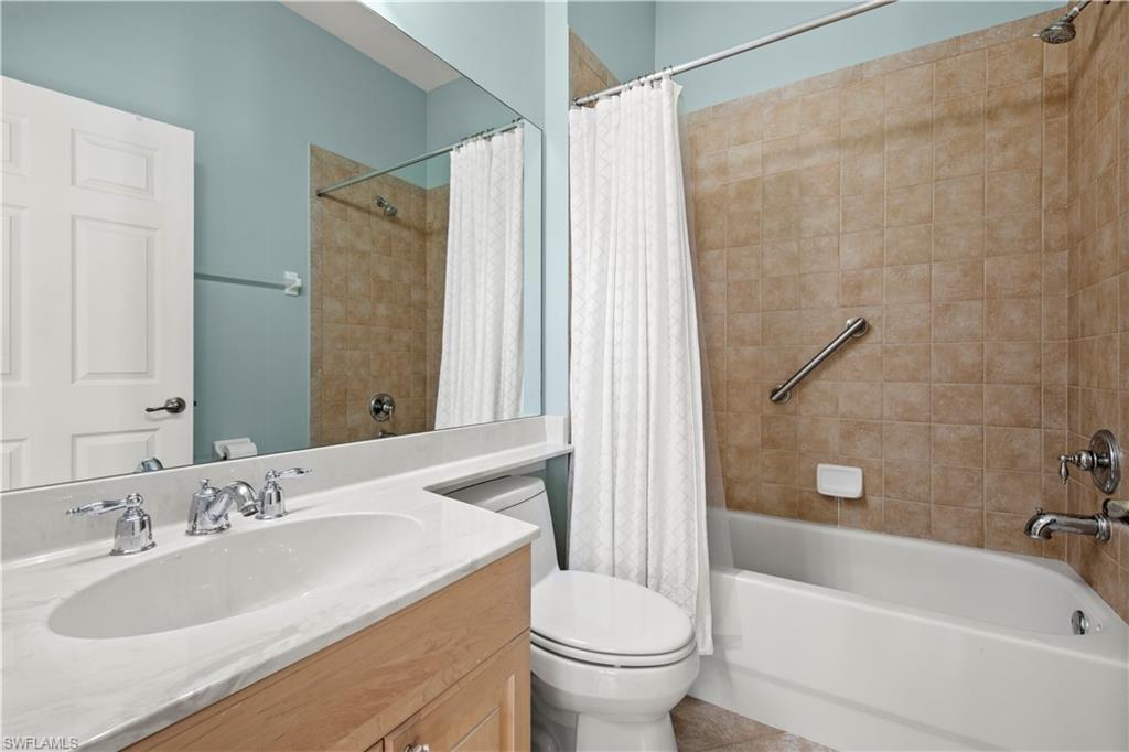 Full bath with vanity and shower / bath combination with curtain