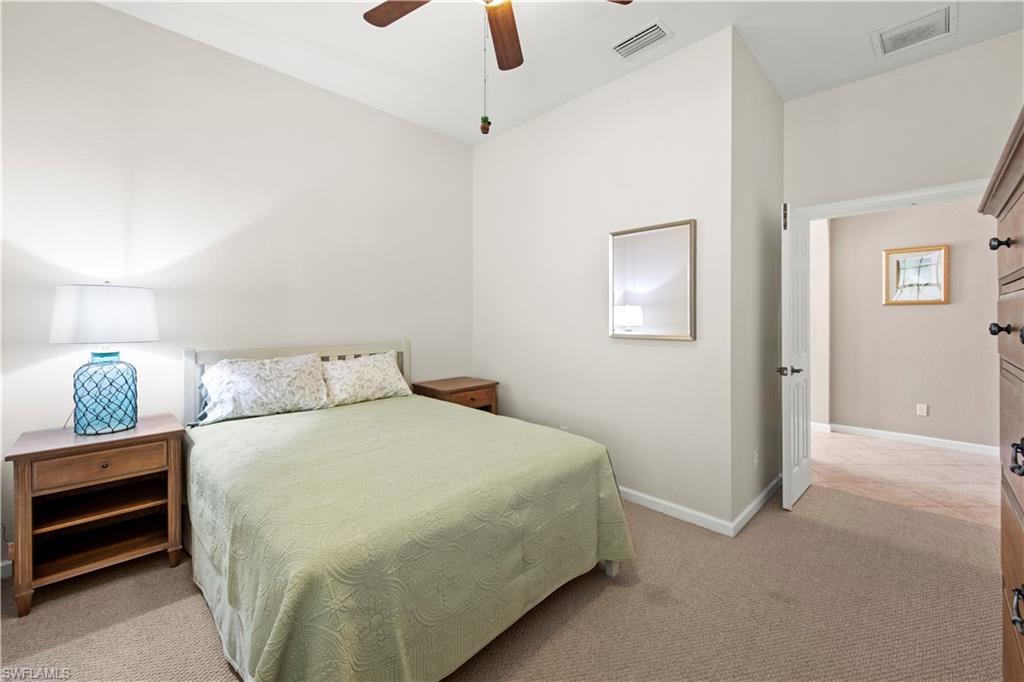 Bedroom featuring light carpet and ceiling fan