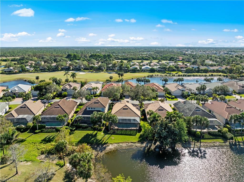 Aerial perspective of suburban area featuring a nearby body of water