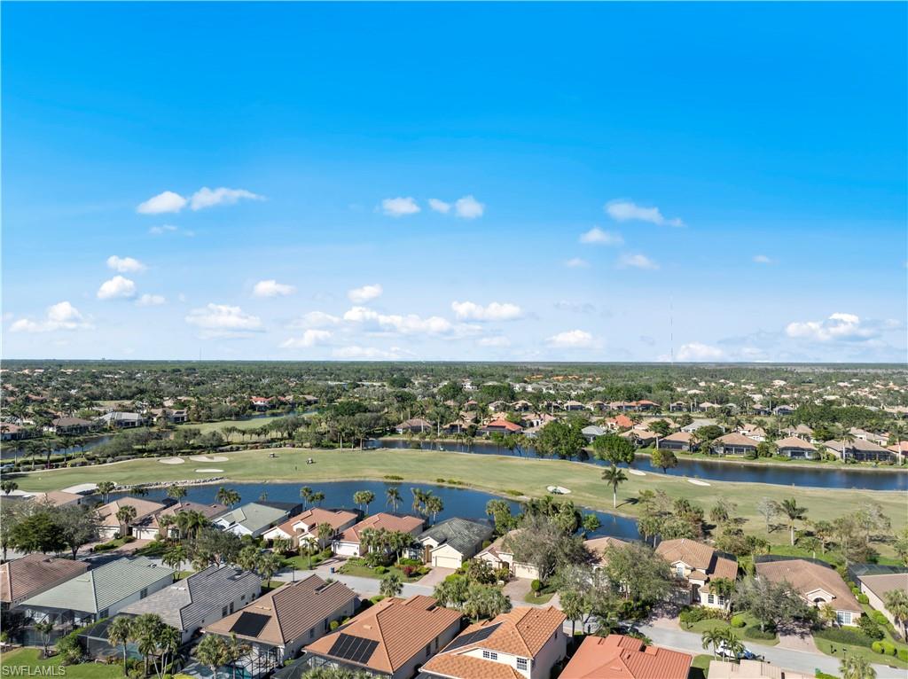 Aerial perspective of suburban area with a large body of water and a local golf course