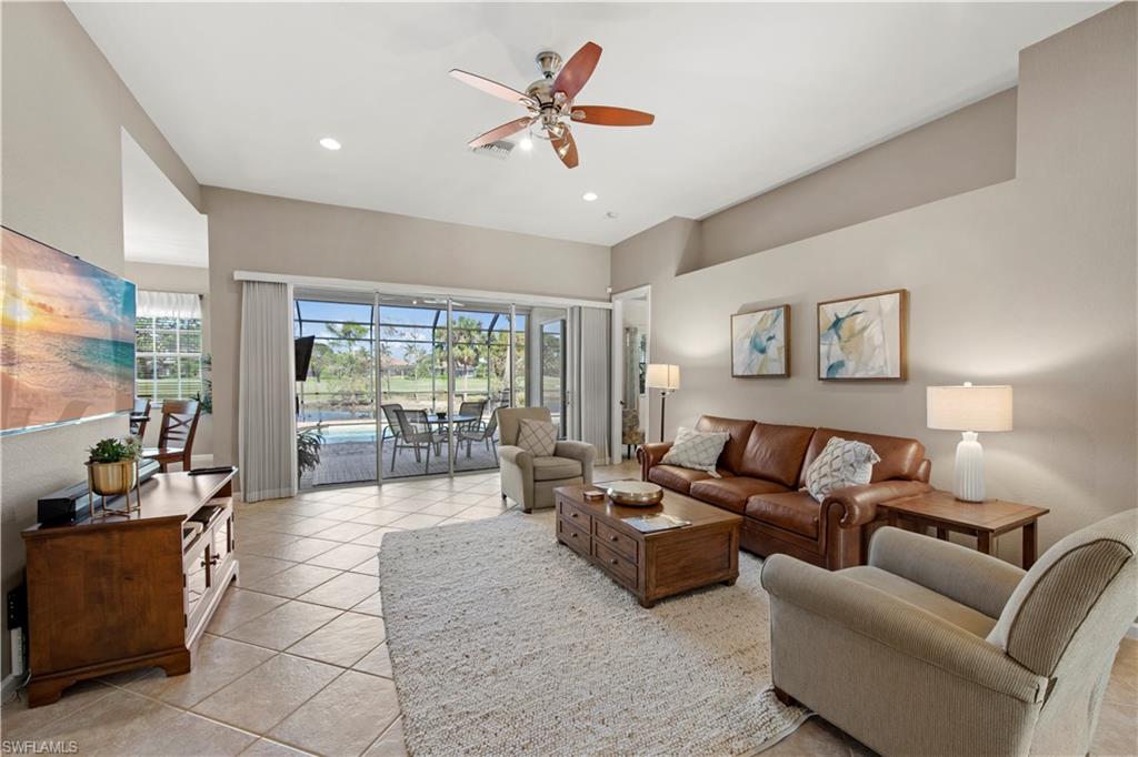 Living area with a sunroom, a ceiling fan, light tile patterned floors, and recessed lighting