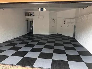 Garage with a textured wall and water heater
