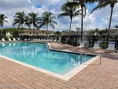 Community pool with a patio