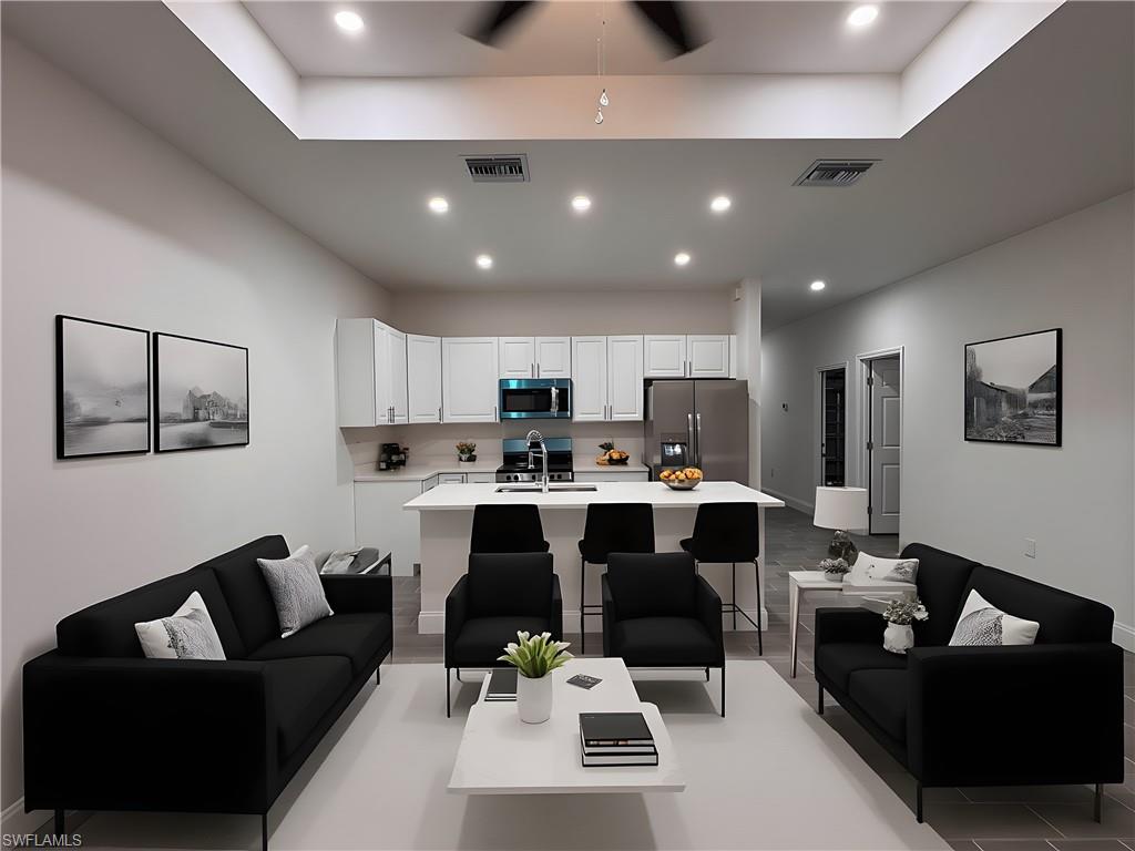 Living room with recessed lighting and a ceiling fan