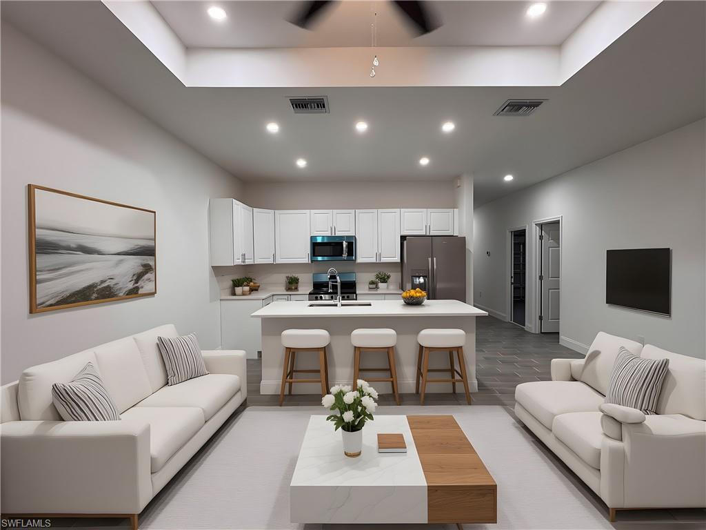 Living room featuring recessed lighting, light wood finished floors, and a ceiling fan