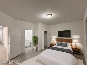 Bedroom with wood tiled floors and ensuite bathroom