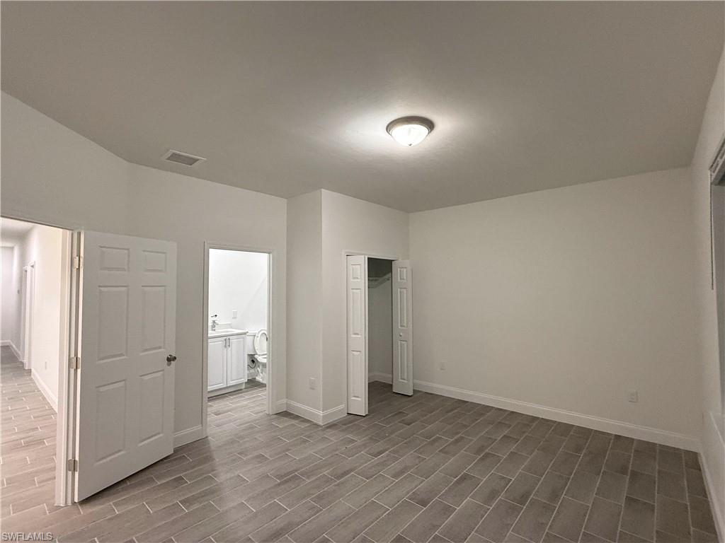 Unfurnished bedroom with a closet and light wood-style flooring