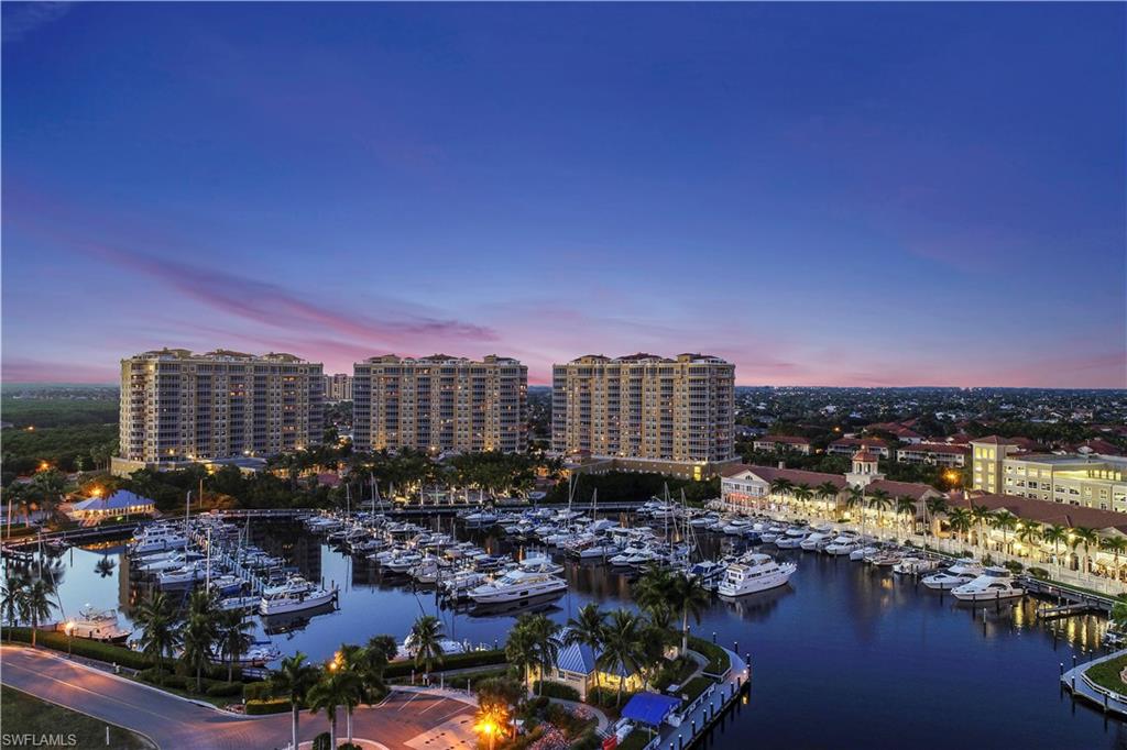 Aerial view at dusk of view of marina, a water view, and a city view