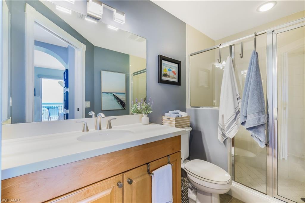 Bathroom featuring vanity and a shower stall