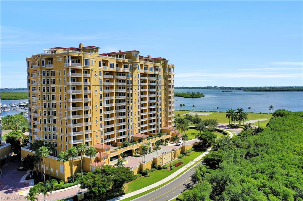 View of apartment building / complex featuring a water view