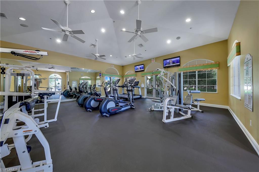 Workout area with high vaulted ceiling and recessed lighting