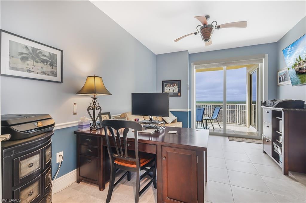 Home office with ceiling fan and light tile patterned flooring
