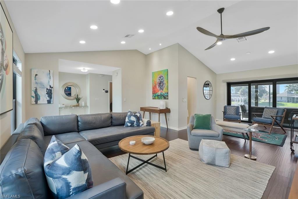 Living room featuring lofted ceiling, wood finished floors, recessed lighting, and ceiling fan