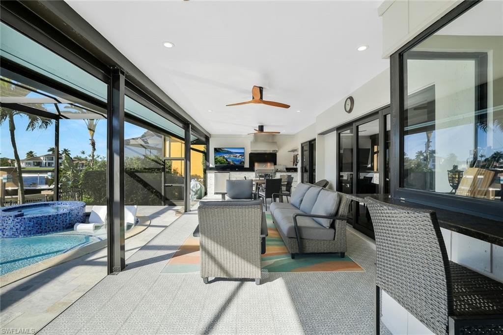 Sunroom / solarium featuring healthy amount of natural light and a jacuzzi
