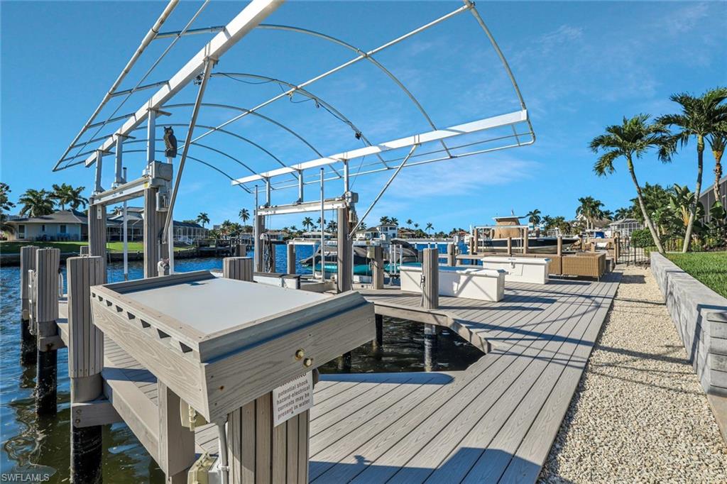 Dock featuring boat lift and a water view