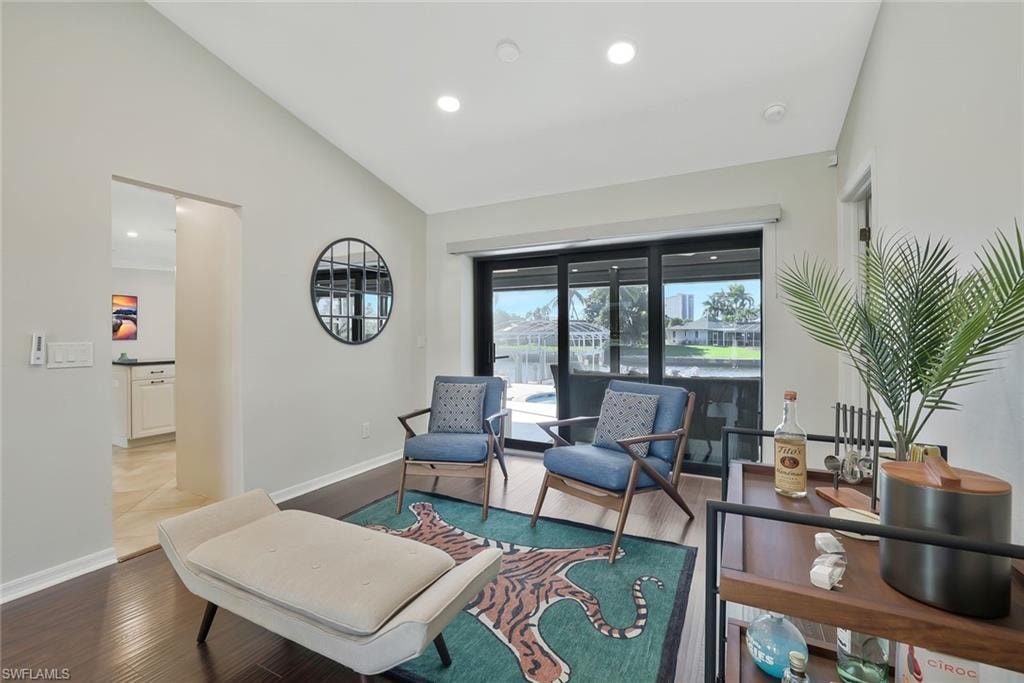 Sitting room featuring recessed lighting, wood finished floors, and high vaulted ceiling