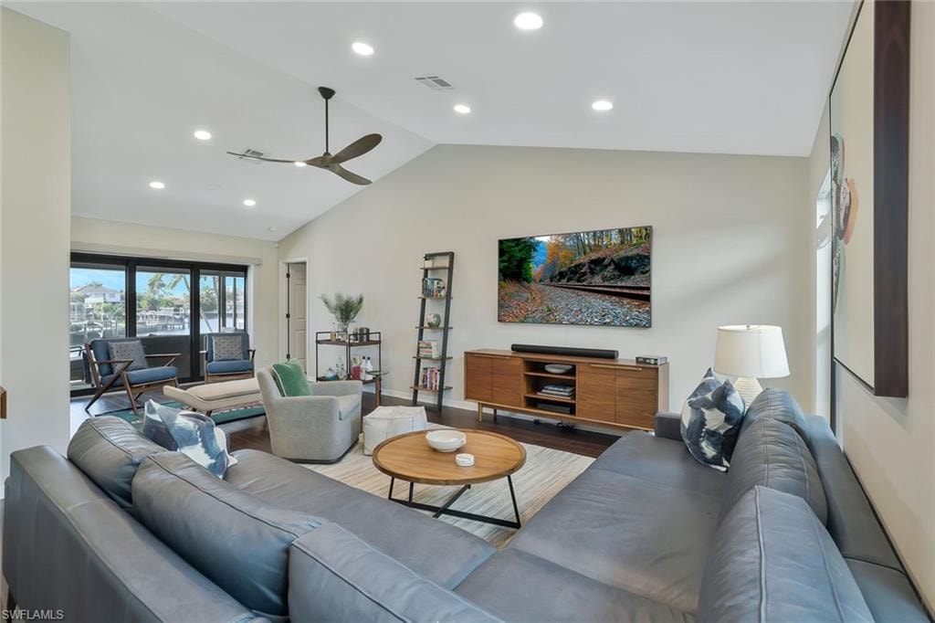 Living room featuring recessed lighting, wood finished floors, high vaulted ceiling, and a ceiling fan