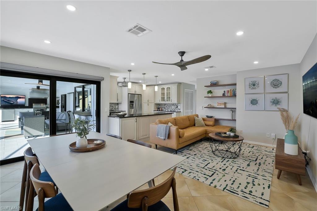 Dining area featuring ceiling fan, light tile patterned floors, and recessed lighting