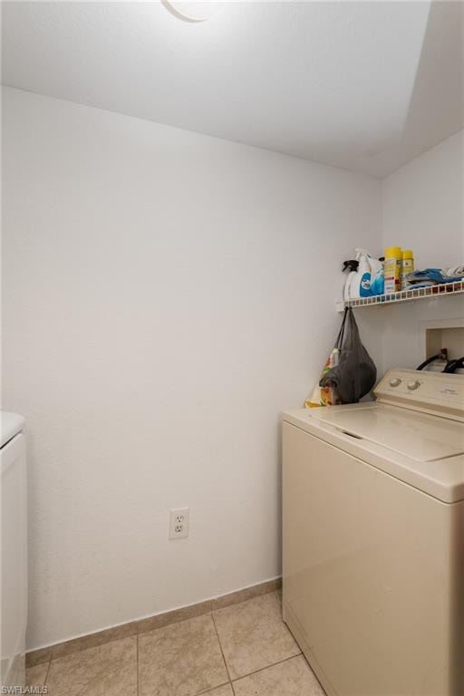 Laundry room featuring washer hookup and light tile patterned floors