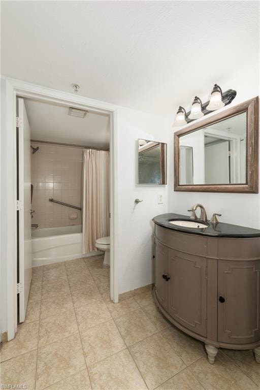 Bathroom with vanity, shower / bath combination with curtain, and light tile patterned flooring
