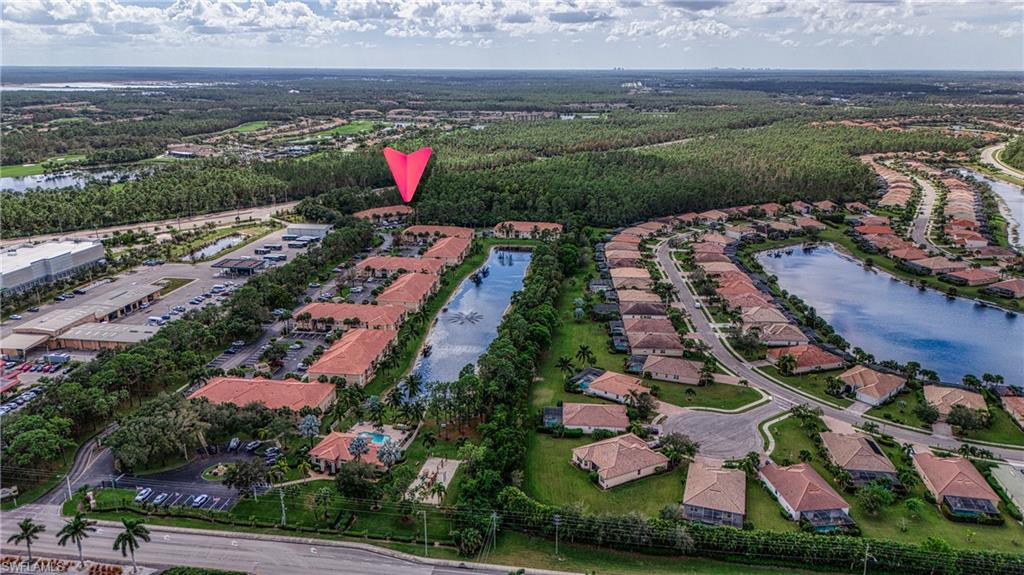 Aerial view of property's location featuring a large body of water and nearby suburban area