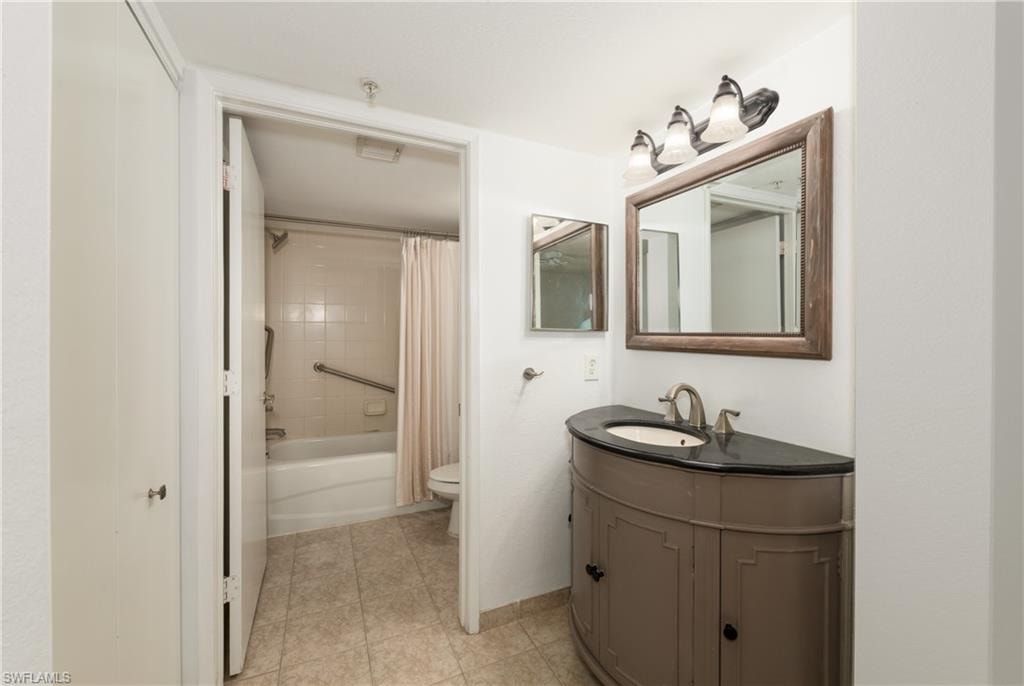 Full bath featuring vanity and shower / bath combo