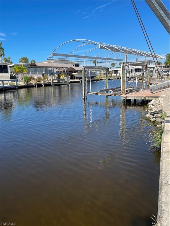 Dock with boat lift and a water view