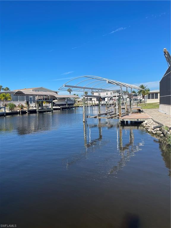 Dock with boat lift and a water view