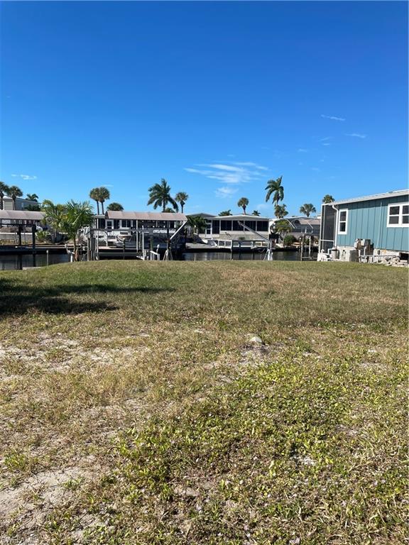 View of grassy yard with a water view