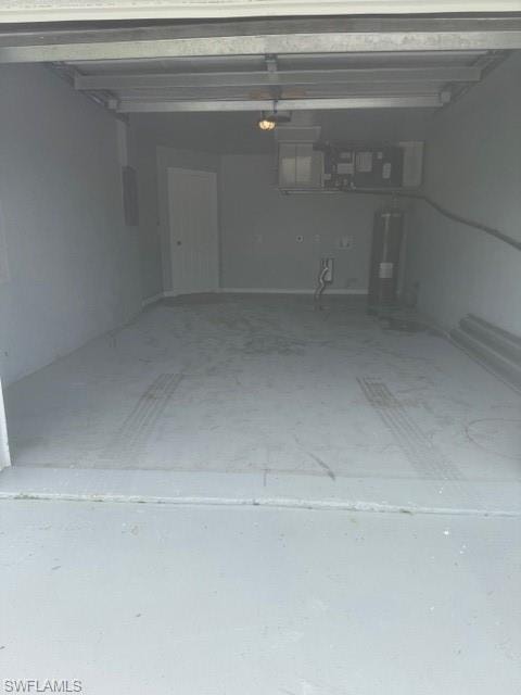Garage featuring water heater and electric panel
