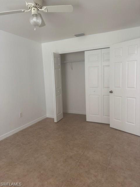 Unfurnished bedroom featuring a closet, a ceiling fan, and light tile patterned flooring