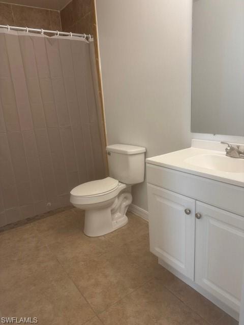 Bathroom featuring vanity, a shower with shower curtain, and light tile patterned flooring