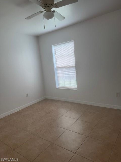 Spare room featuring light tile patterned flooring and a ceiling fan