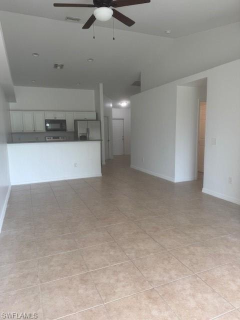 Unfurnished living room featuring ceiling fan, lofted ceiling, and light tile patterned floors