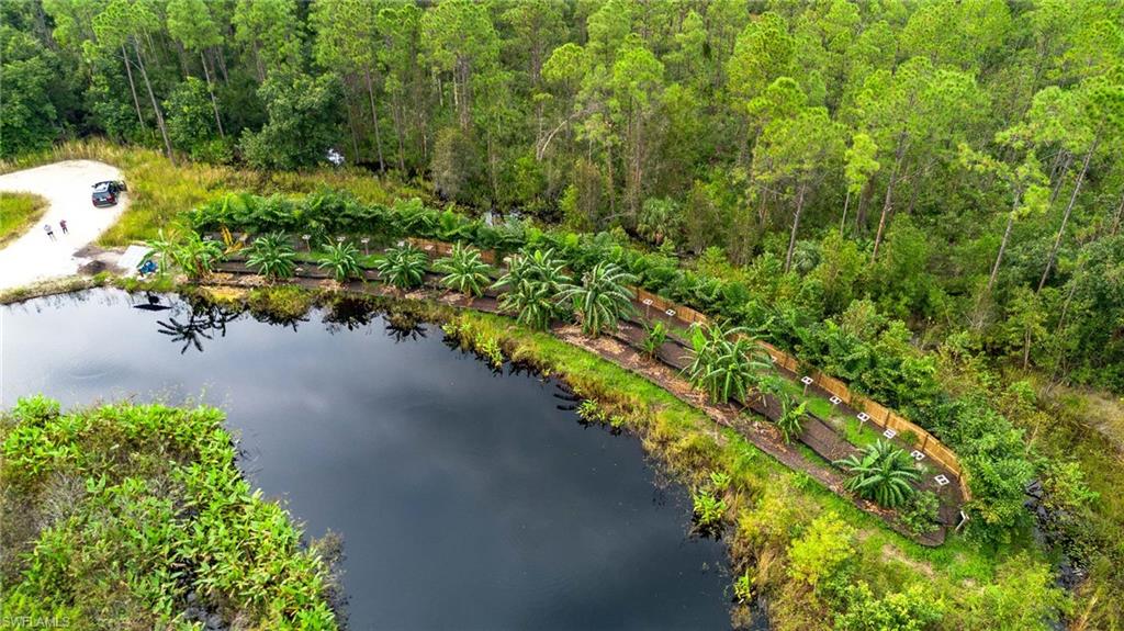 Birds eye view of property with a water view