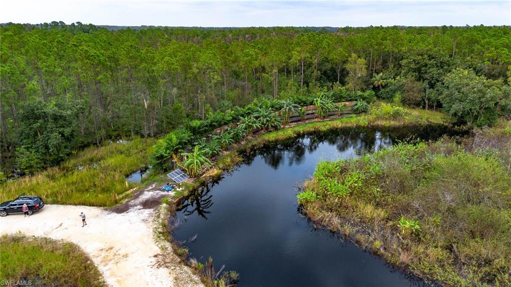 Birds eye view of property with a water view