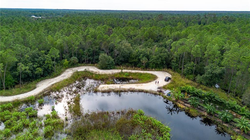 Birds eye view of property with a water view
