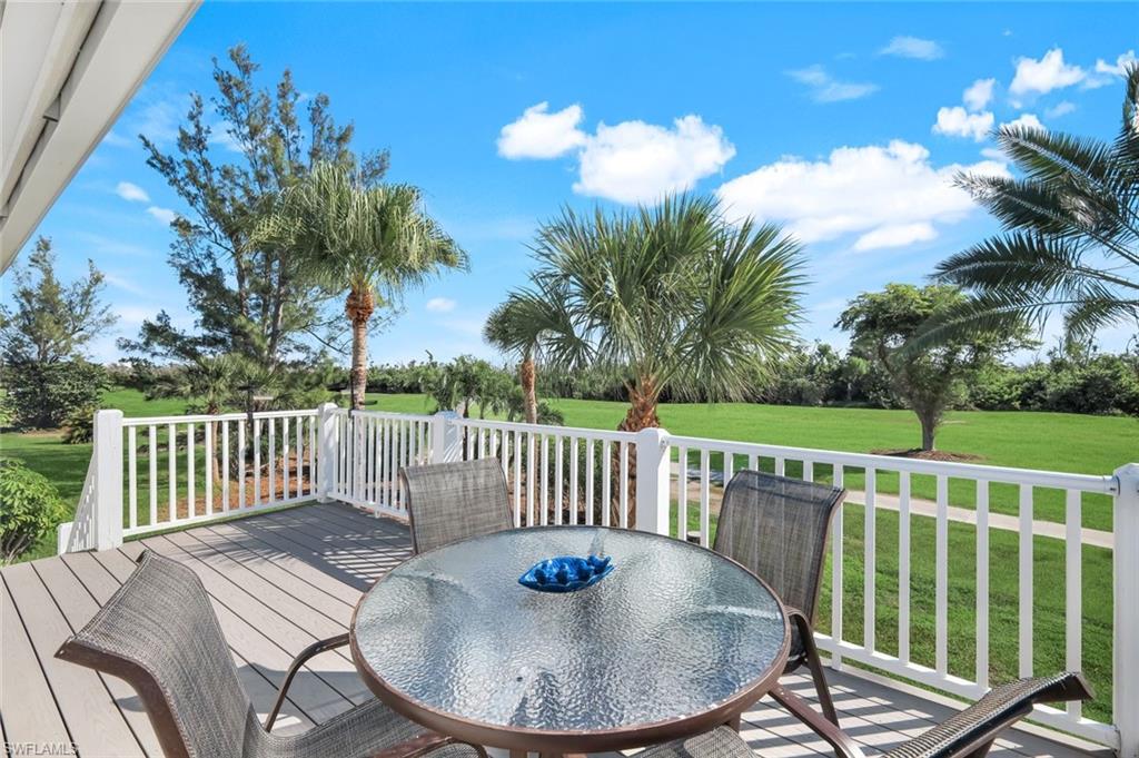 Wooden terrace with a yard and outdoor dining area
